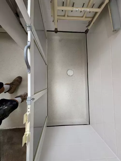 Aerial view of installed wet room vinyl flooring in an accessible bathroom space